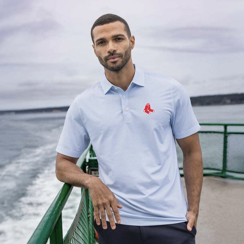 Man wearing a light blue polo with an embroidered chest logo
